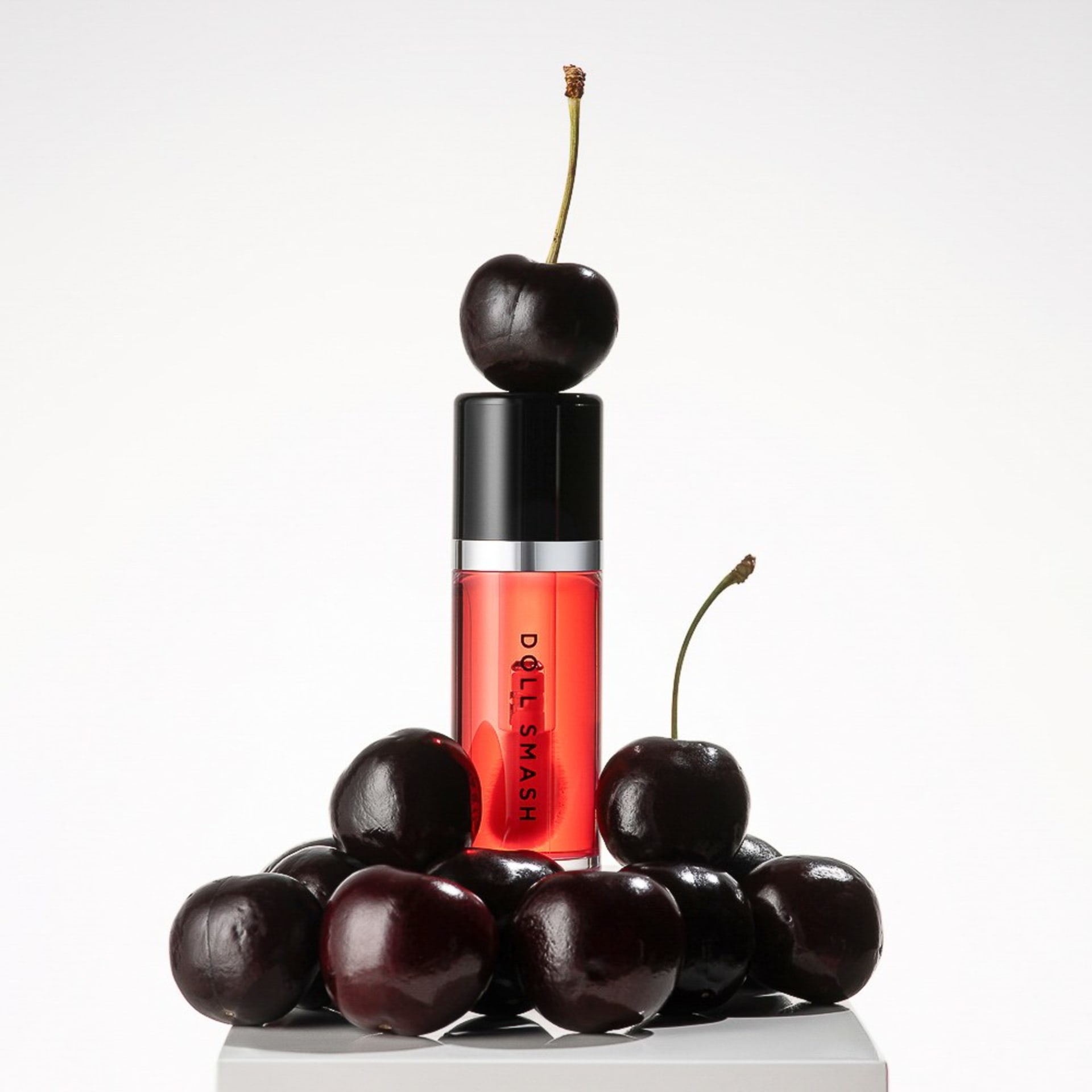 Cherry red lip gloss creative fruit styling studio hero - beauty photography UK
