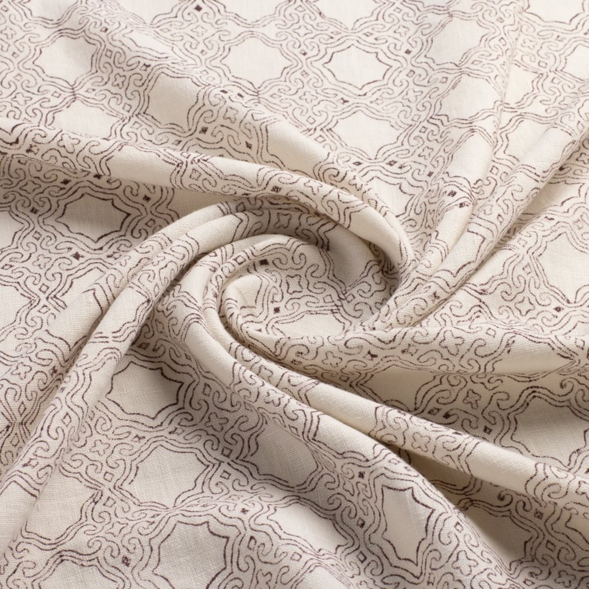 Cream patterned fabric with swirl detail studio shot - fabric swatch photography UK