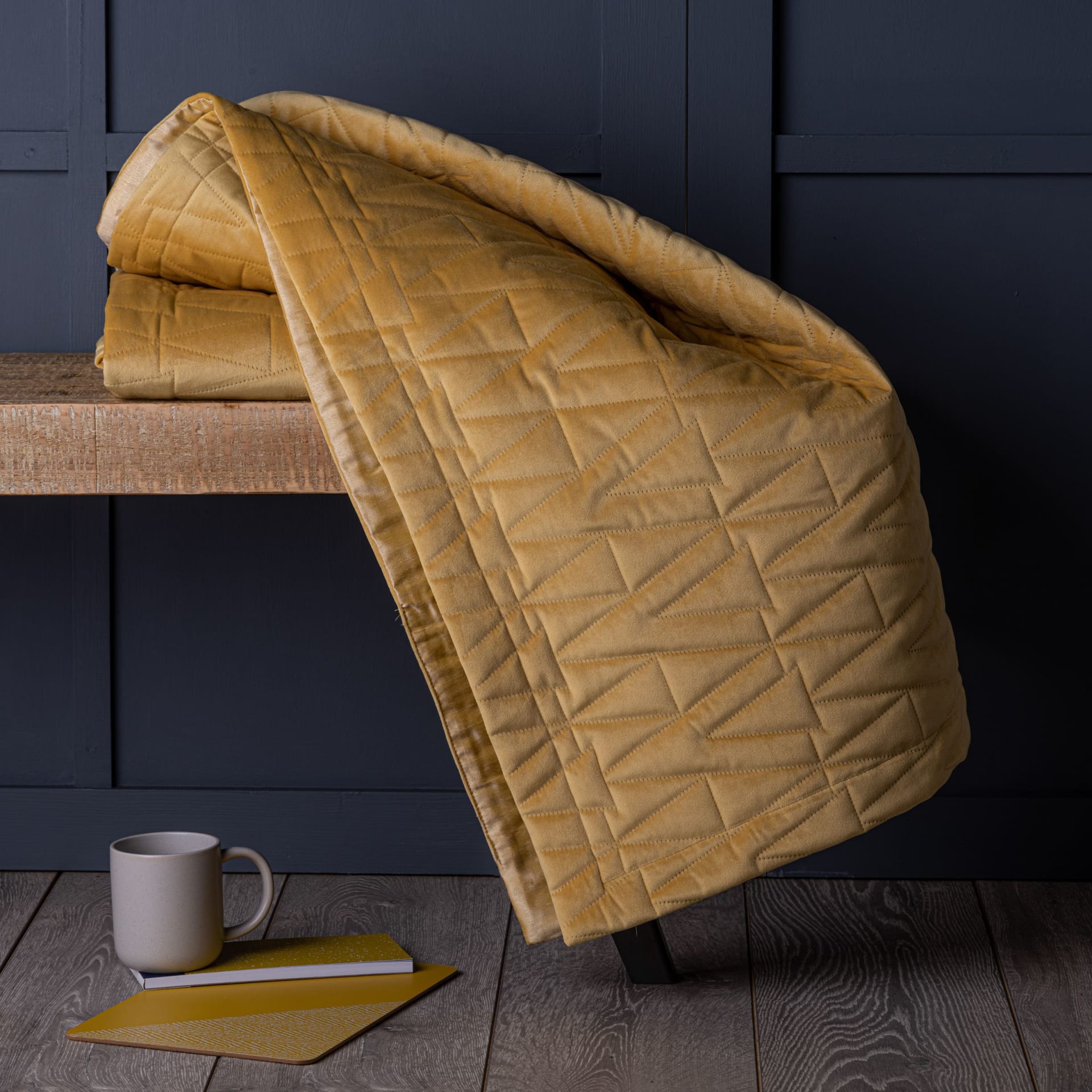 Gold velvet quilted throw on dark sofa room composite - digital composite photography UK