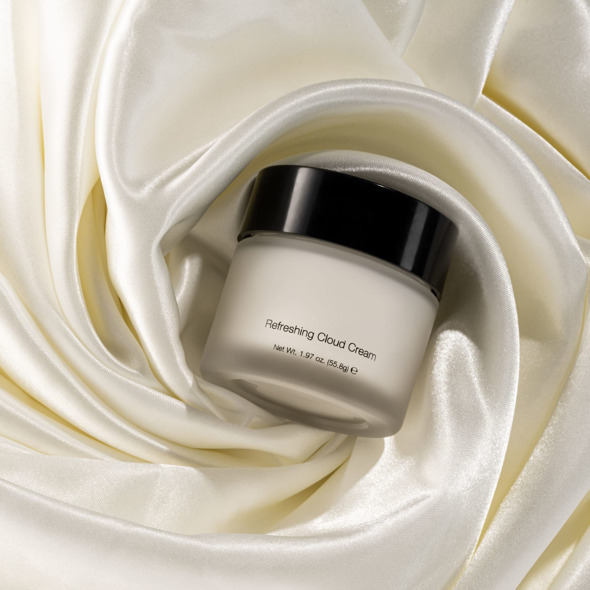 Luxury skincare cream jar on silk fabric lifestyle photography - beauty styling UK
