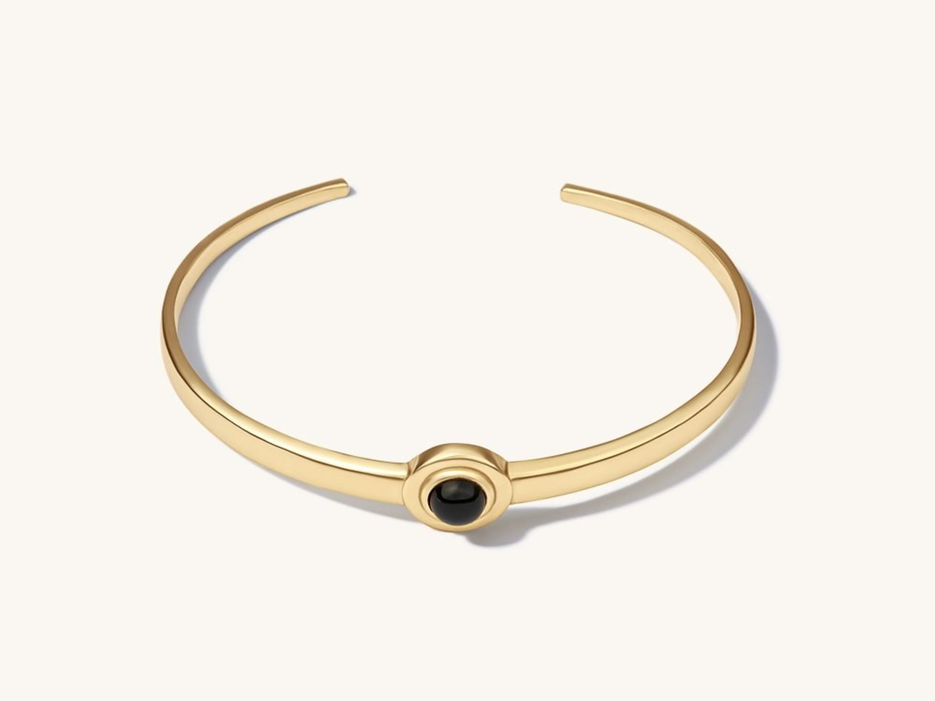 Gold cuff bracelet with black onyx stone - luxury bracelet packshot photography UK