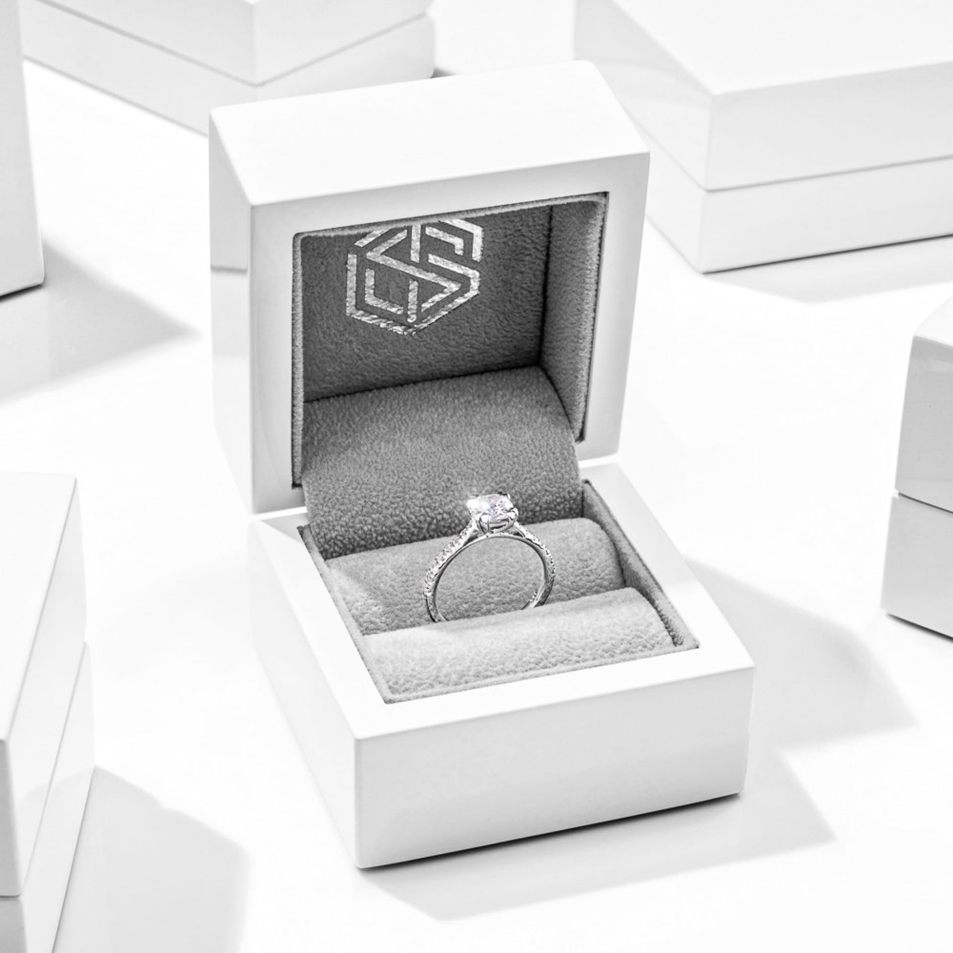 Diamond engagement ring in luxury white box - premium jewellery gift photography UK