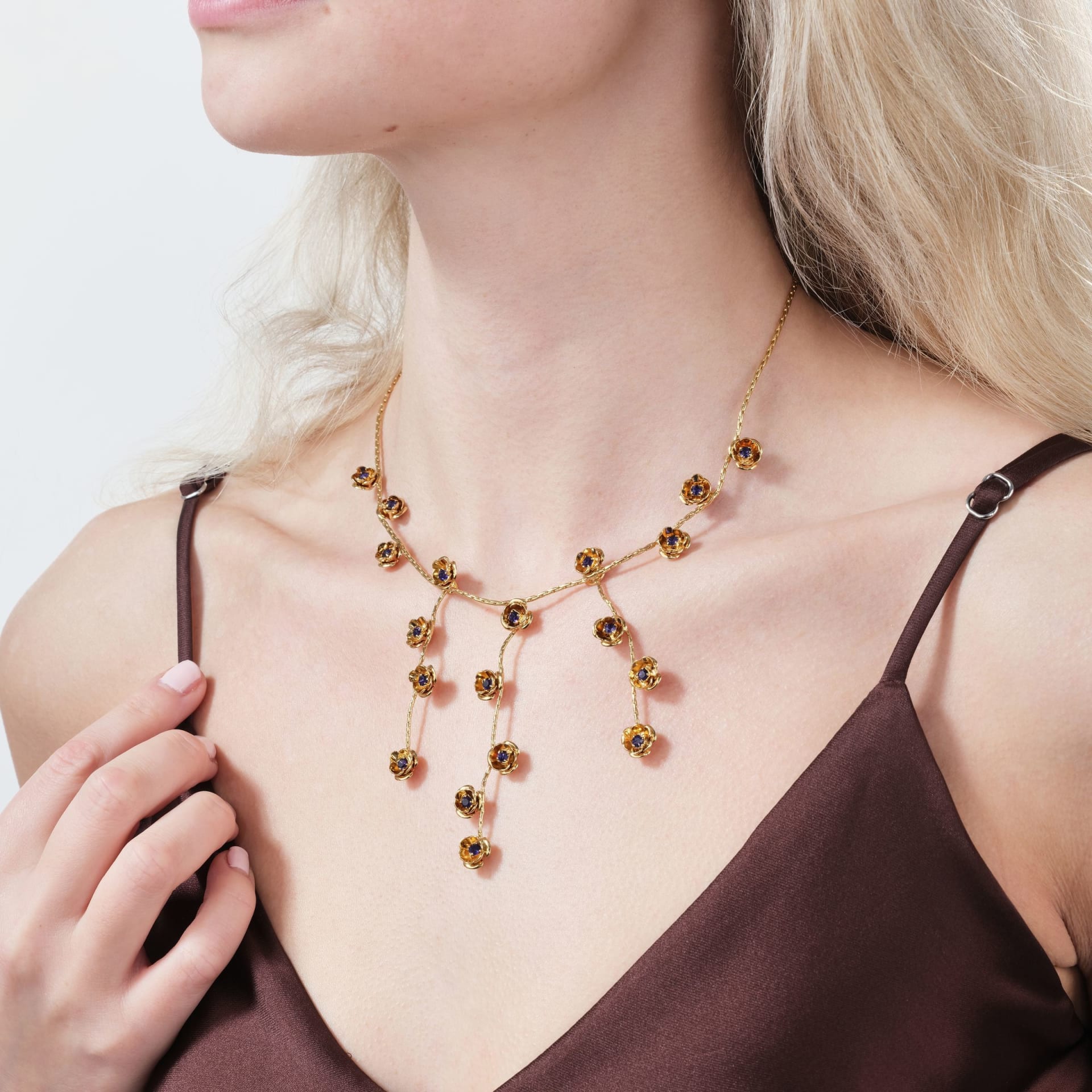 Gold floral sapphire necklace on model - elegant jewellery lifestyle photography UK