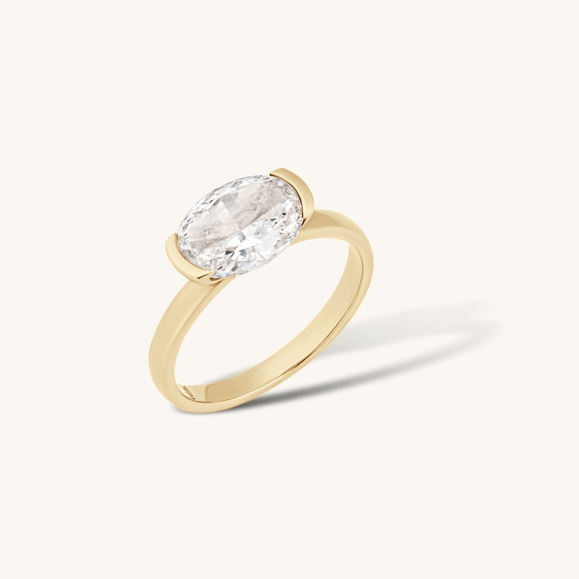 Oval diamond gold ring on white background - luxury ring photography UK