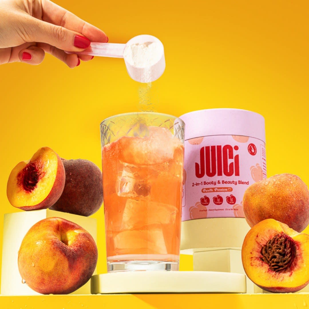 JUICI peach supplement powder being poured into a glass with peaches on a yellow set