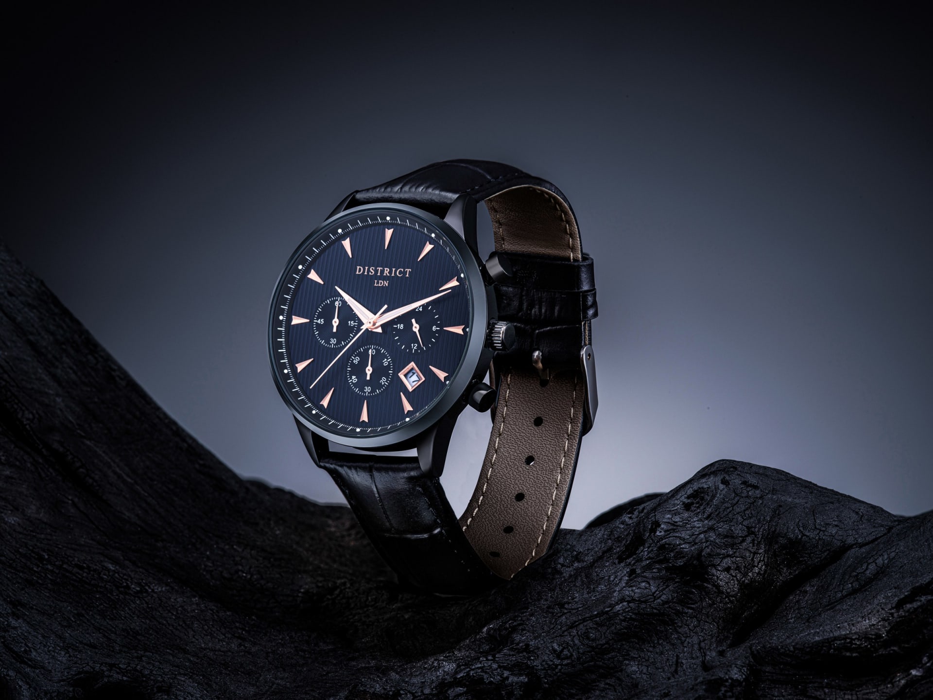 Black chronograph watch leather strap lifestyle dark setting - watch product photography UK