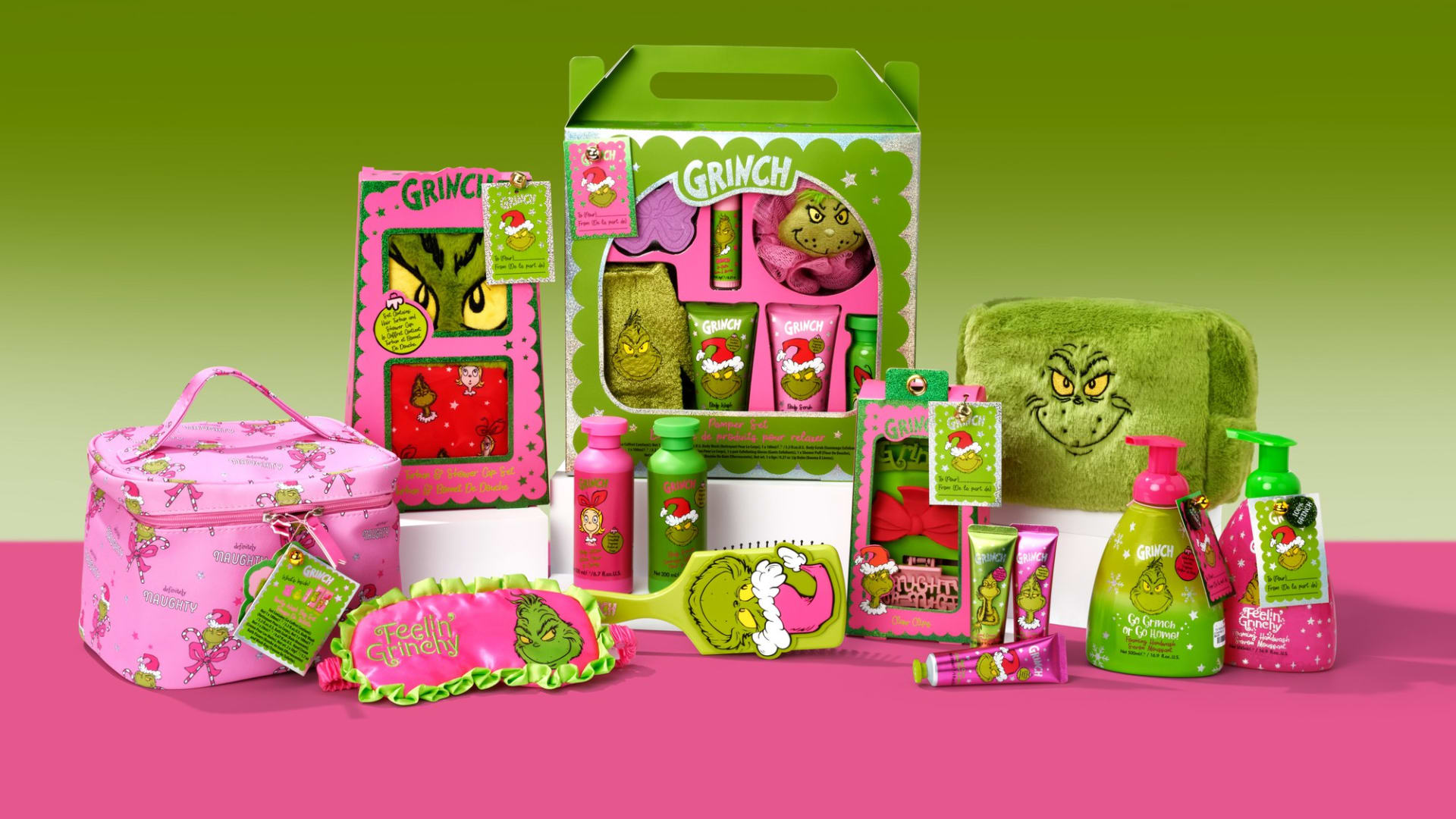 H&A Grinch bath and body gifts arranged together on a pink and green set