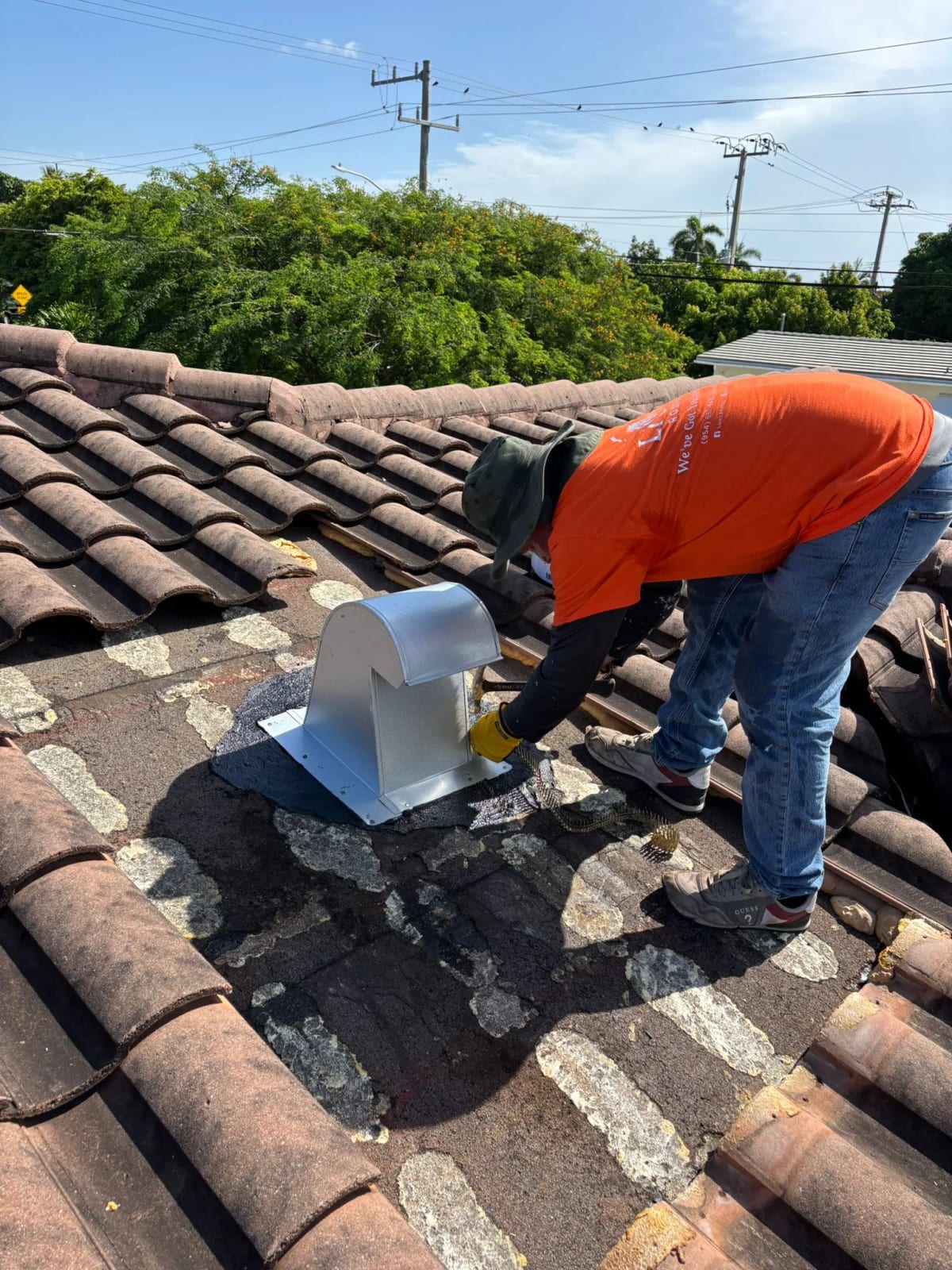 Lionz Roofing contractor installing roof vent during tile roof repair