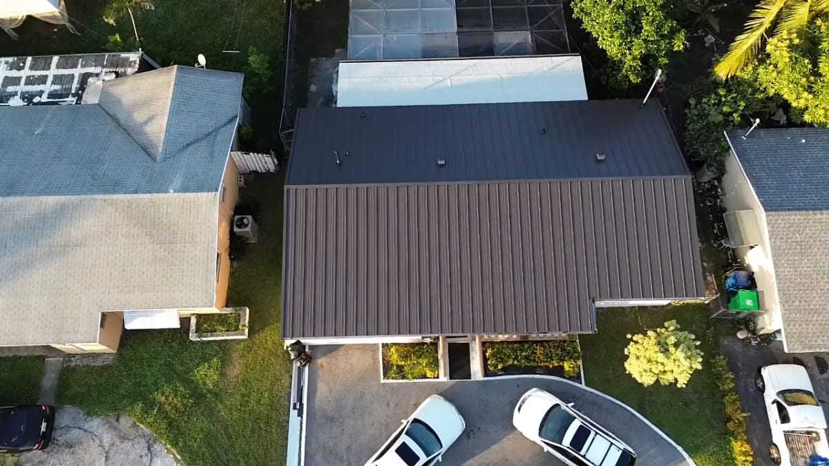 Roof installers laying a new roof on a South Florida home — Lionz Roofing