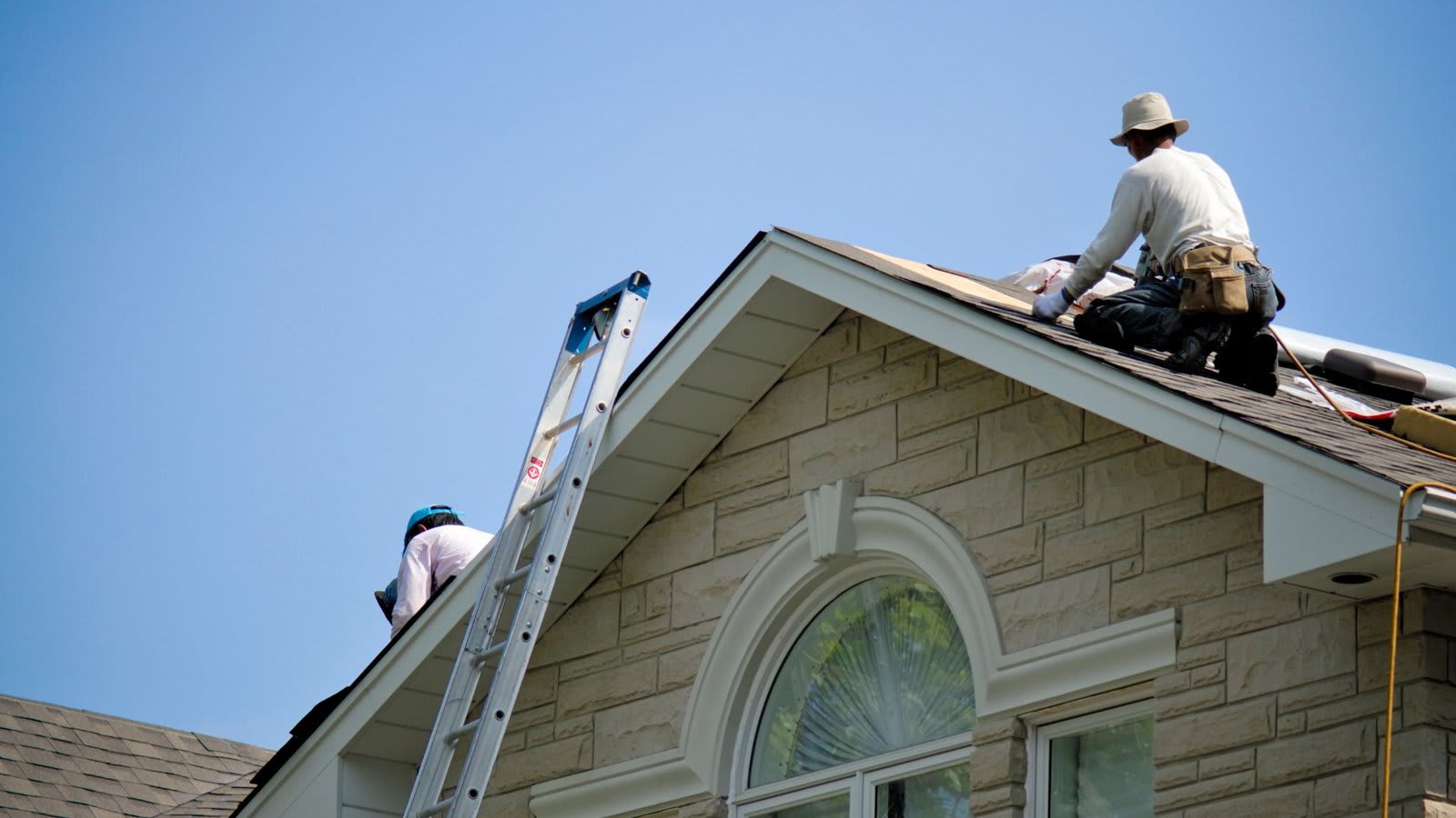 Roofers preparing a roof for waterproofing in South Florida