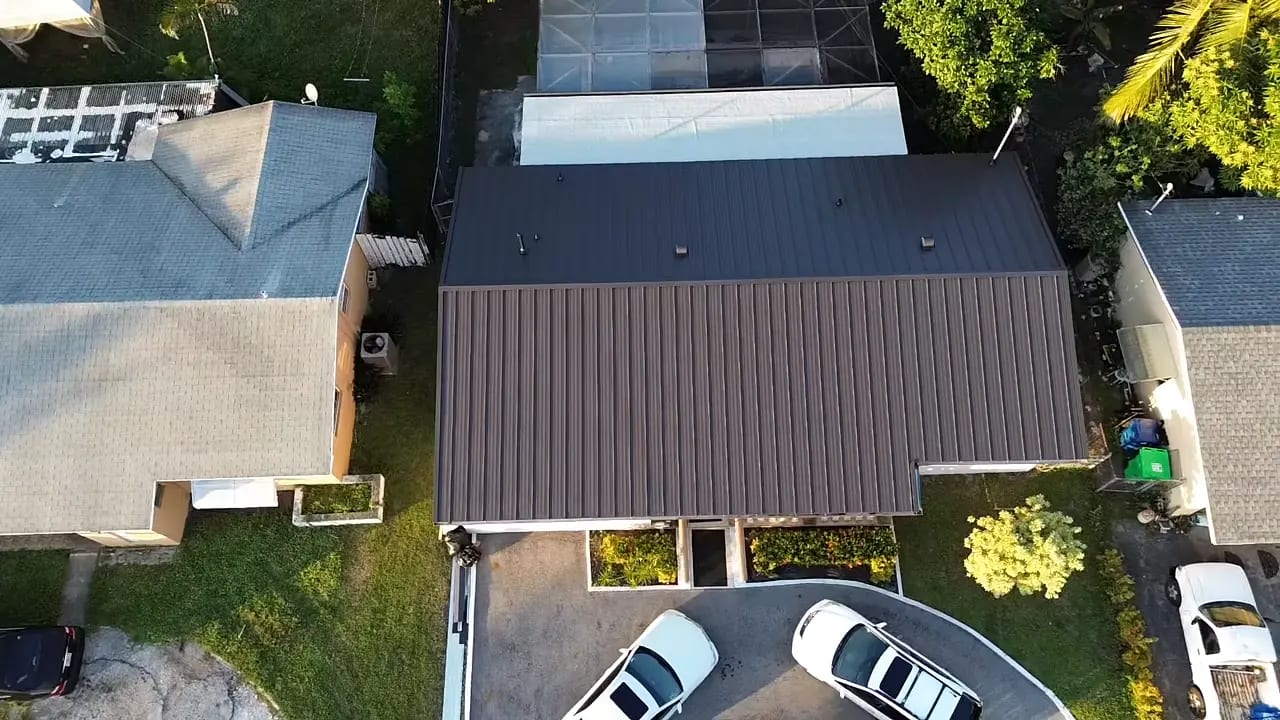 Aerial view of newly installed metal roof after residential roof replacement