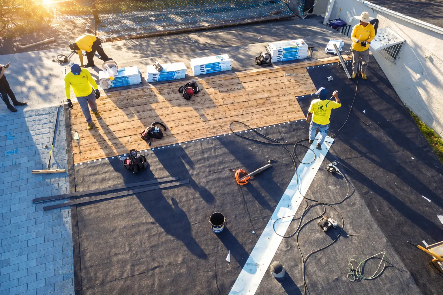 Emergency roof repair crew tarping a damaged roof — Lionz Roofing