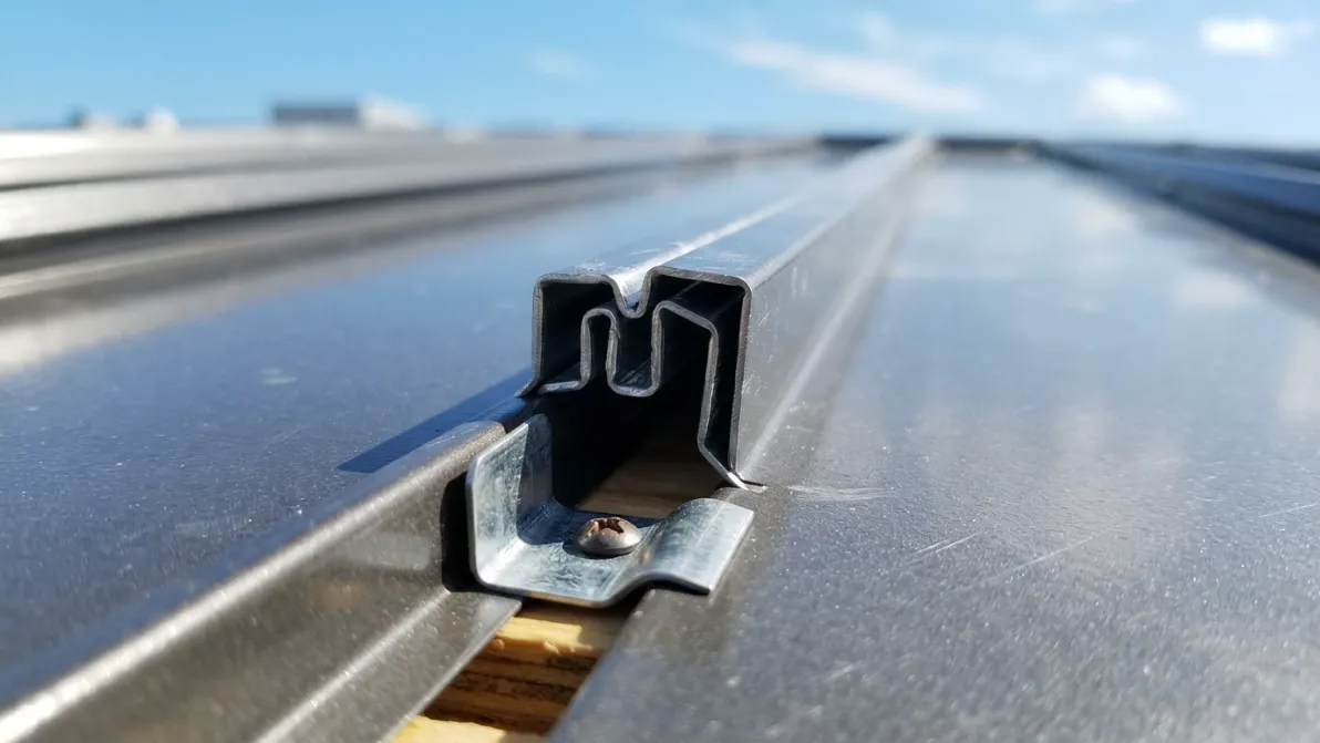 Close-up of HVHZ-rated metal roofing clip and fastener system