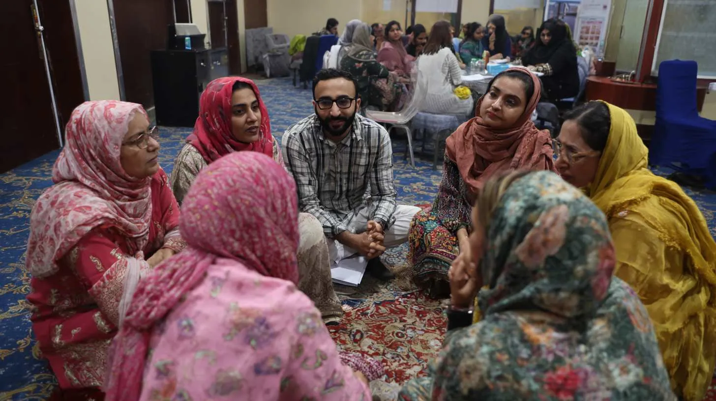 People sitting on floor in circle group in mental health setting