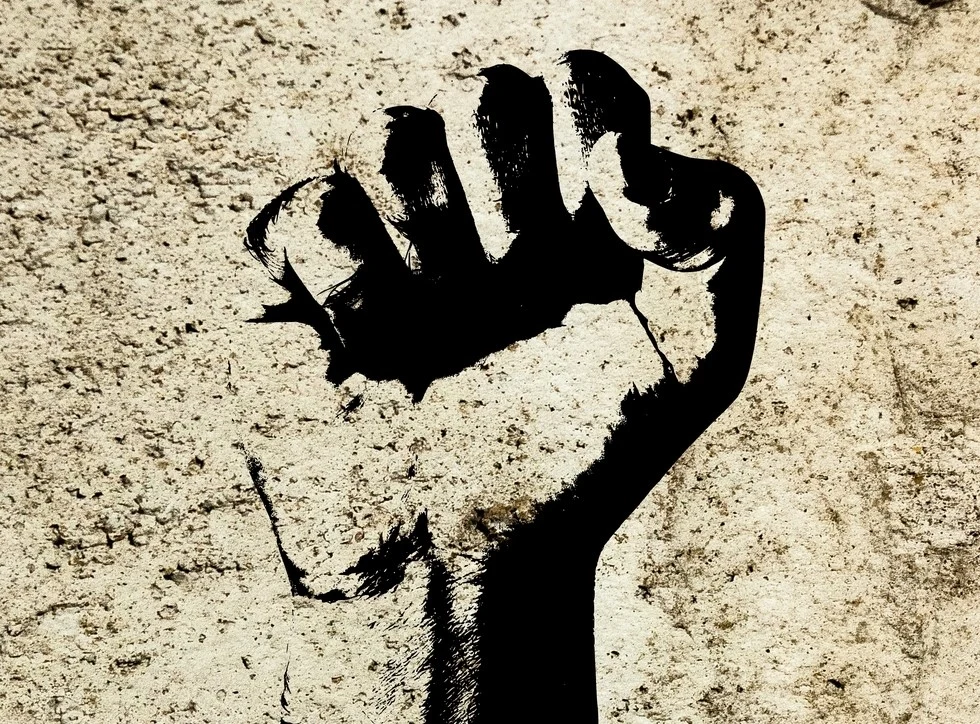 Raised fist as a symbol of solidarity used in political violence