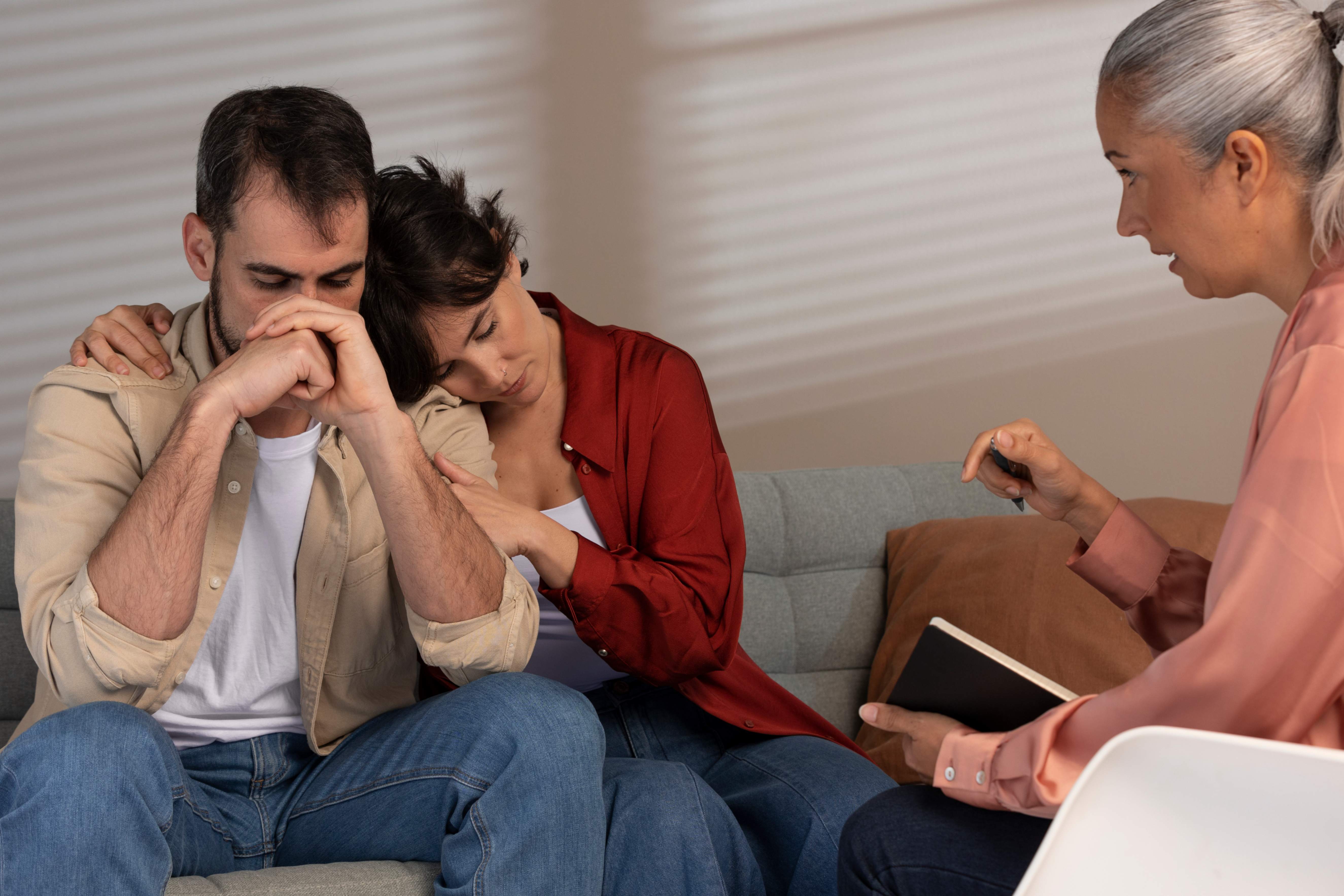 A woman supporting her depressed husband during therapy session