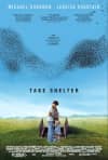 Film poster for Take Shelter, featuring a man and child against a blue sky, exploring themes of mental illness and anxiety.