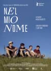 Four children sitting on a grassy hillside, featured in the film Nel Mio Nome, addressing themes of identity and mental health.