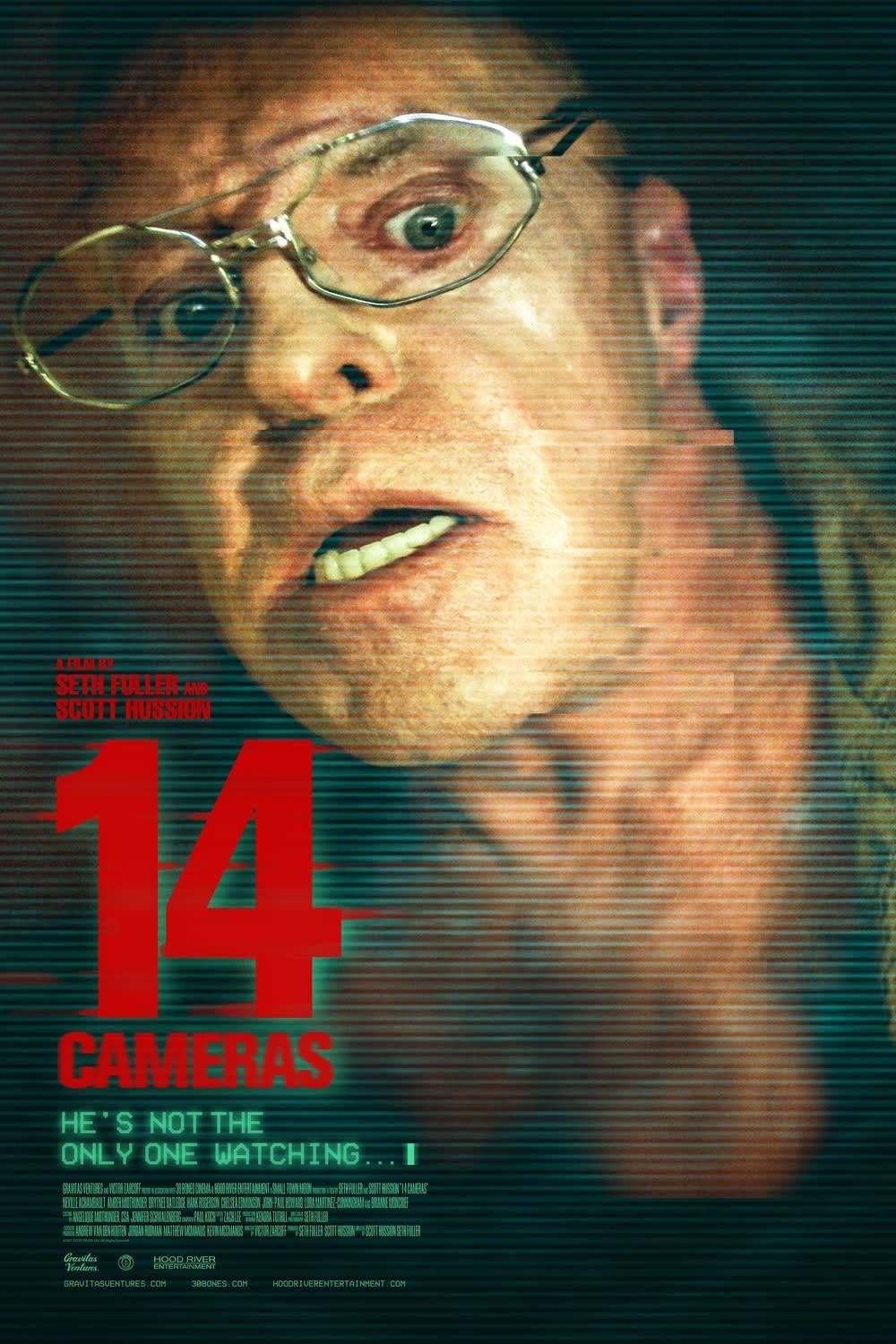 Close-up of a terrified man wearing glasses, from the movie 14 Cameras, highlighting themes of voyeurism and surveillance.