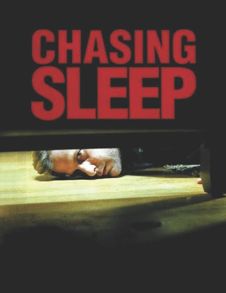 A man lying on the floor in a dark setting, with the title CHASING SLEEP prominently displayed above.