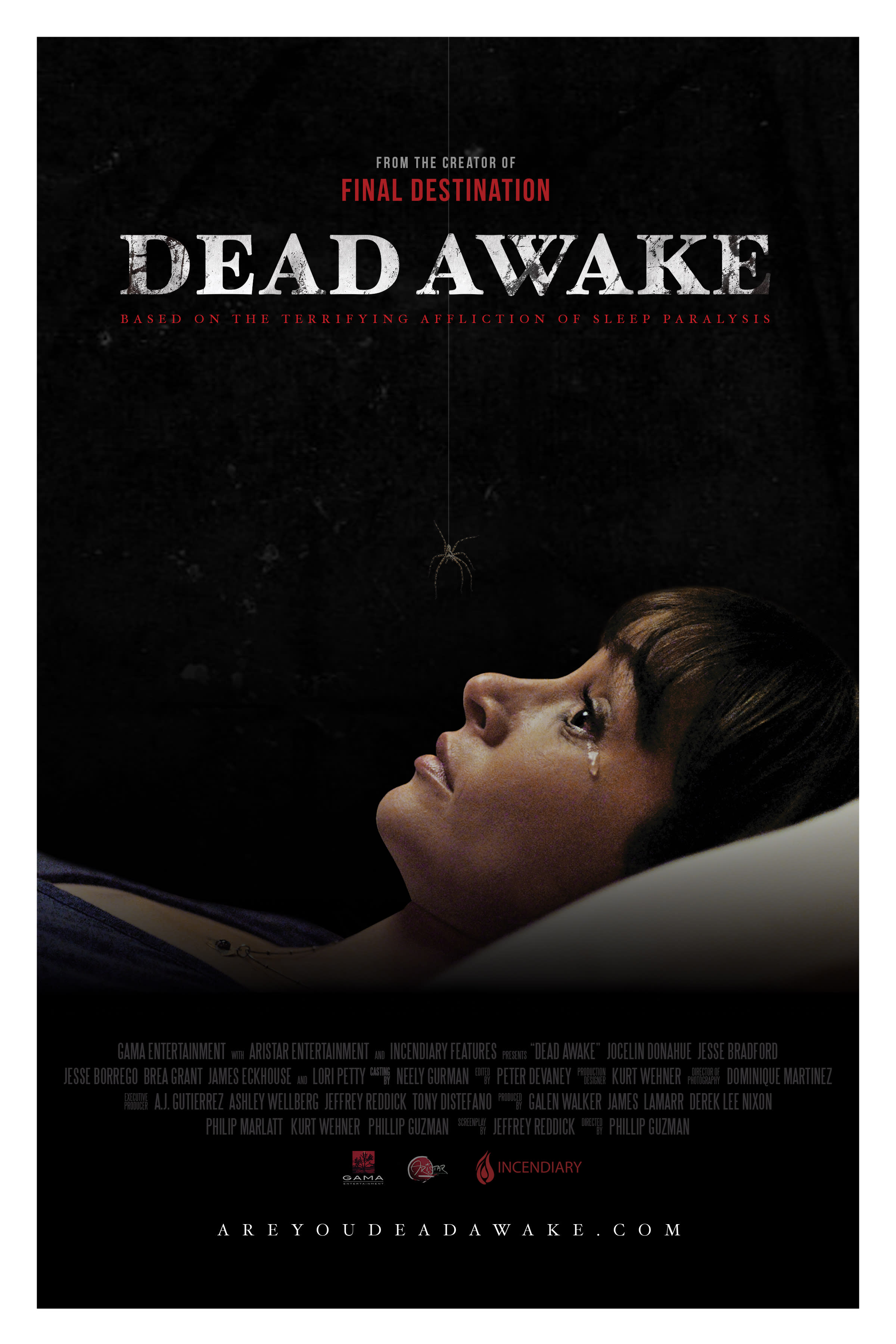 A woman experiencing fear and anxiety while lying in bed, depicted in the movie Dead Awake, about sleep paralysis.