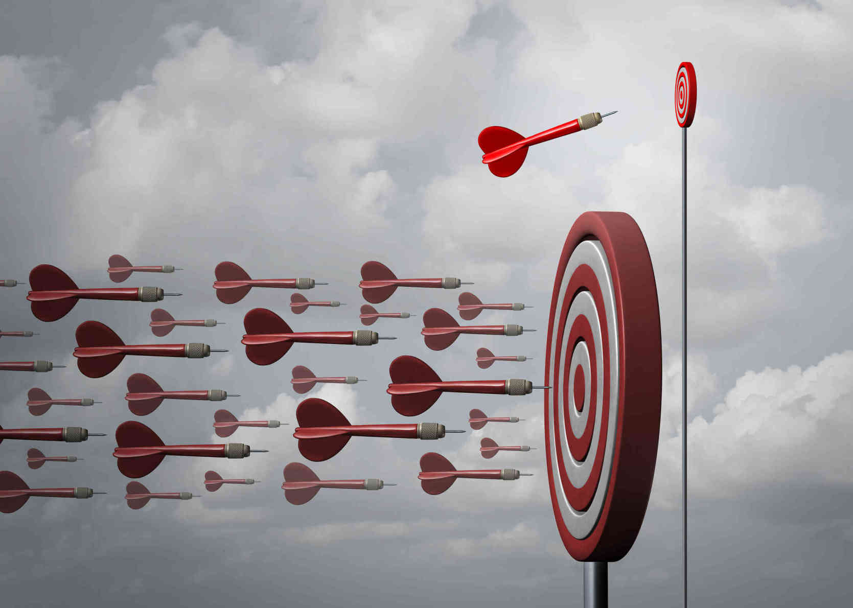 Red darts flying towards a bullseye target, symbolizing goal setting and achievement in psychology practices.
