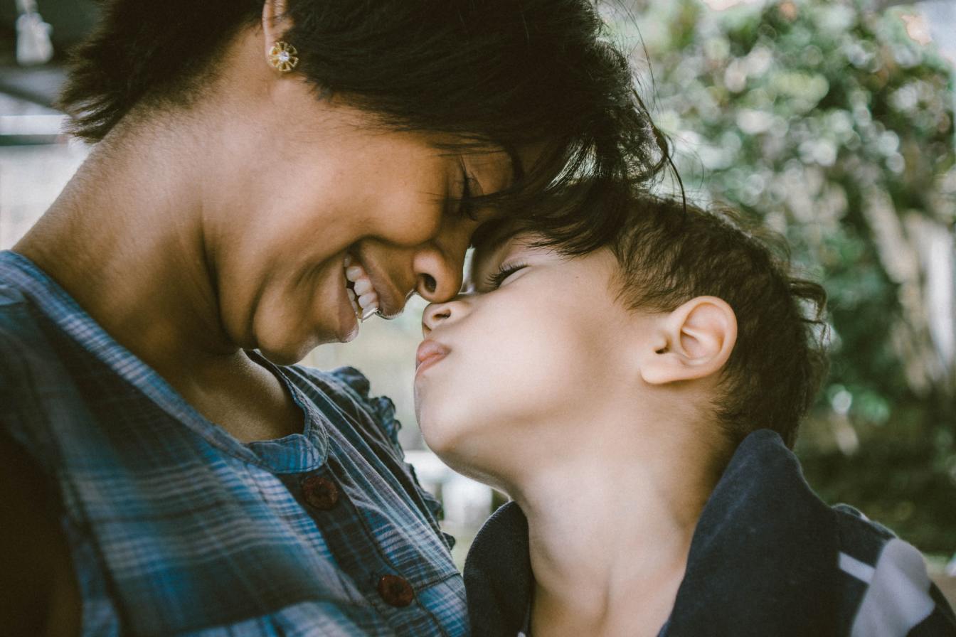 Mother and child sharing a joyful moment, emphasizing the bond formed through attachment and emotional connection.