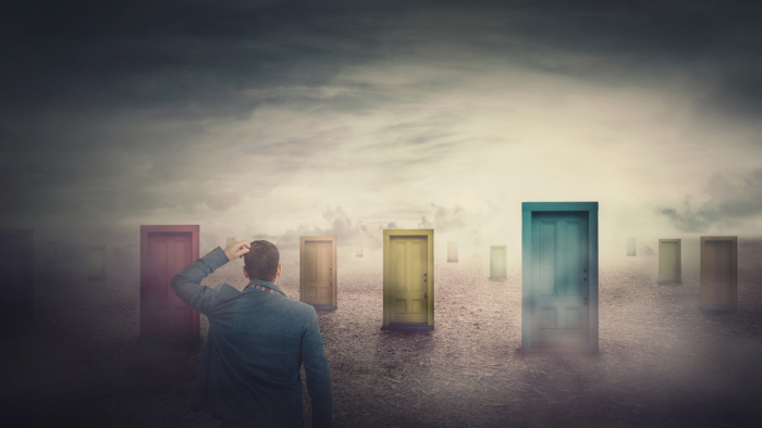 Person standing in confusion before multiple colorful doors, symbolizing choices and existential dilemmas in modern life.