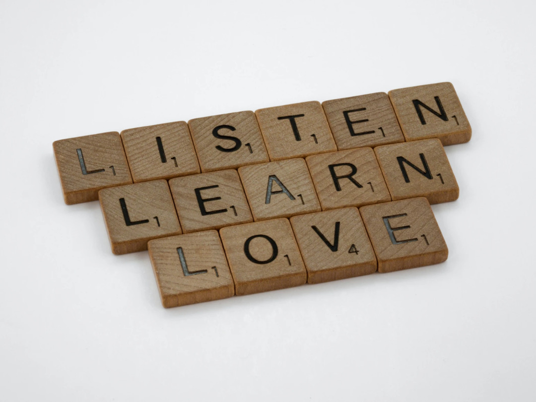 Scrabble tiles spelling LISTEN, LEARN, and LOVE, emphasizing core principles for healthier relationships.