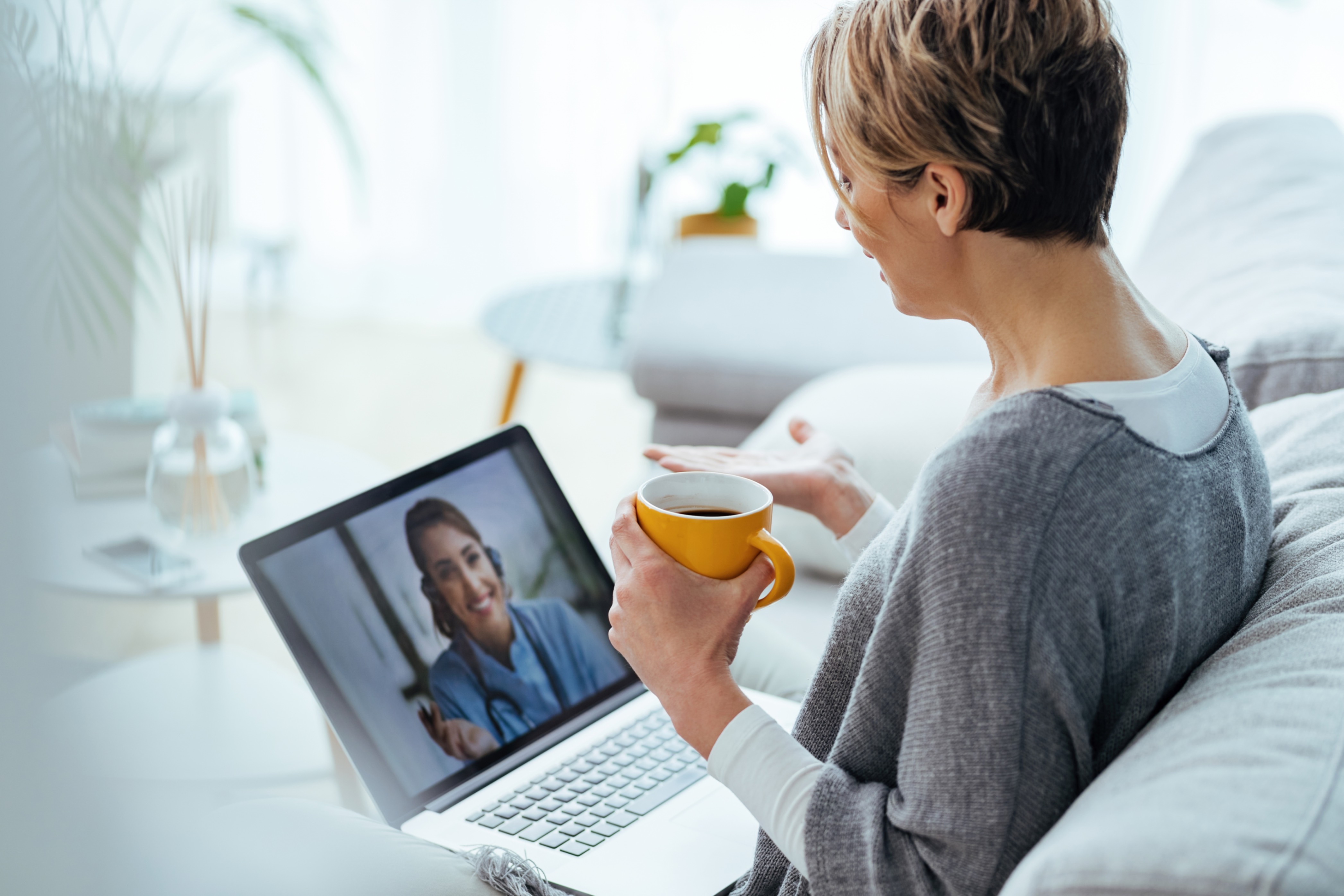 An elderly woman having an online therapy session