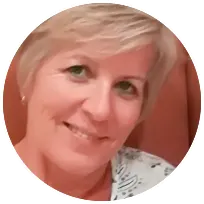 Smiling woman with short blonde hair, representing a licensed therapist focused on supporting individuals and families.