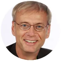 Smiling man wearing glasses, demonstrating the approachable attitude of a professional counsellor specializing in therapy.