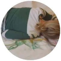 Woman resting on a bed, illustrating the importance of mental health support and self-care in therapy practices.