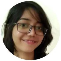 Young woman with glasses smiling, representing a compassionate psychologist dedicated to counseling and therapy.