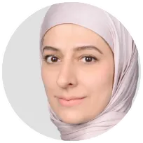 Professional headshot of a female psychologist wearing a light-colored hijab, emphasizing mental health expertise.