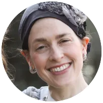 Smiling woman wearing a headscarf, representing a supportive therapist for expats and multicultural relationships in Tel Aviv.