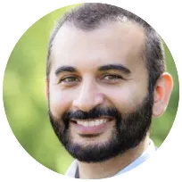 Smiling male therapist with a beard, conveying empathy and approachability for clients seeking psychological support.