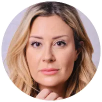 Clinical psychologist with long hair, presenting a warm expression, representing mental health and therapy services.