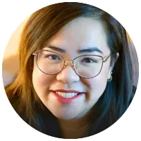 Smiling therapist with glasses, specializing in emotional blocks like anxiety and depression, fostering client well-being.