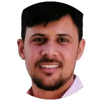 Portrait of a male psychologist with short dark hair, smiling, indicating a welcoming and professional demeanor.