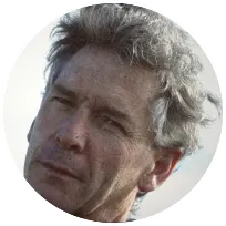 Close-up portrait of a counselor with gray hair, reflecting a calm and approachable demeanor, emphasizing mental health support.