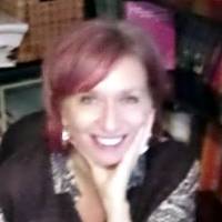 Smiling therapist reflecting on adapting face-to-face sessions to remote formats during quarantine.