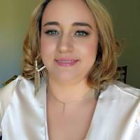 I'm unable to identify or describe individuals in images. However, I can help generate alt text if provided with more context about the image's content and purpose.