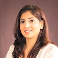 Professional woman smiling, representing the guidance provided by life coaching and counseling for personal growth.