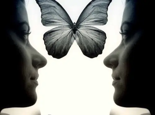 Silhouette of two women's faces facing each other with a butterfly between them, symbolizing transformation and connection in psychoanalysis.