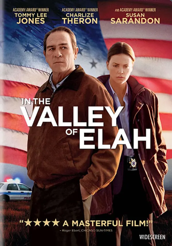 Alt text: Movie poster for 'In the Valley of Elah,' featuring Tommy Lee Jones and Charlize Theron against an American flag backdrop.