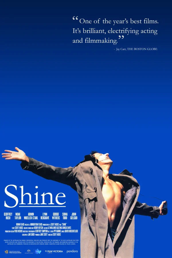Alt text: Promotional poster for 'Shine' featuring a man in a coat against a blue background, highlighting a positive review.