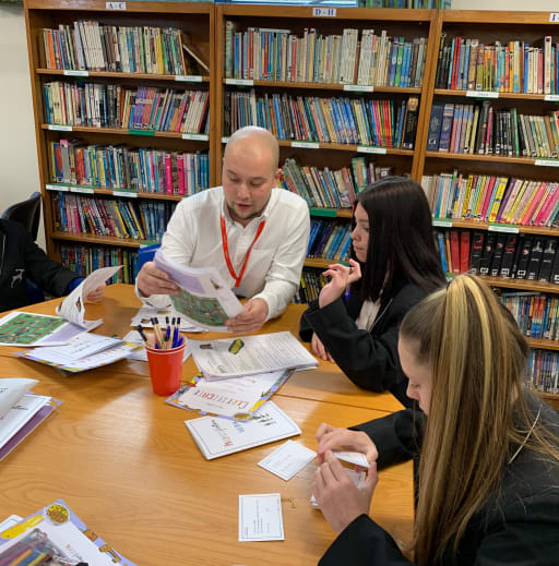 A teacher and a student looking at a Project Partners project pack