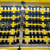 Yellow and black pit cover safety net with 'Caution No Step' warning at an automotive quick lube bay, ensuring safety around the service pit. - Image 5 of 0