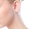 Swirling 14k white gold diamond huggie earrings with 0.55 carats of diamonds. - Image 4 of 0